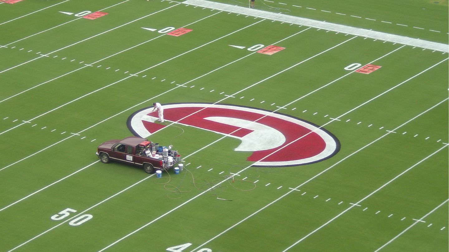 Truck Painting a Logo on a Football Field